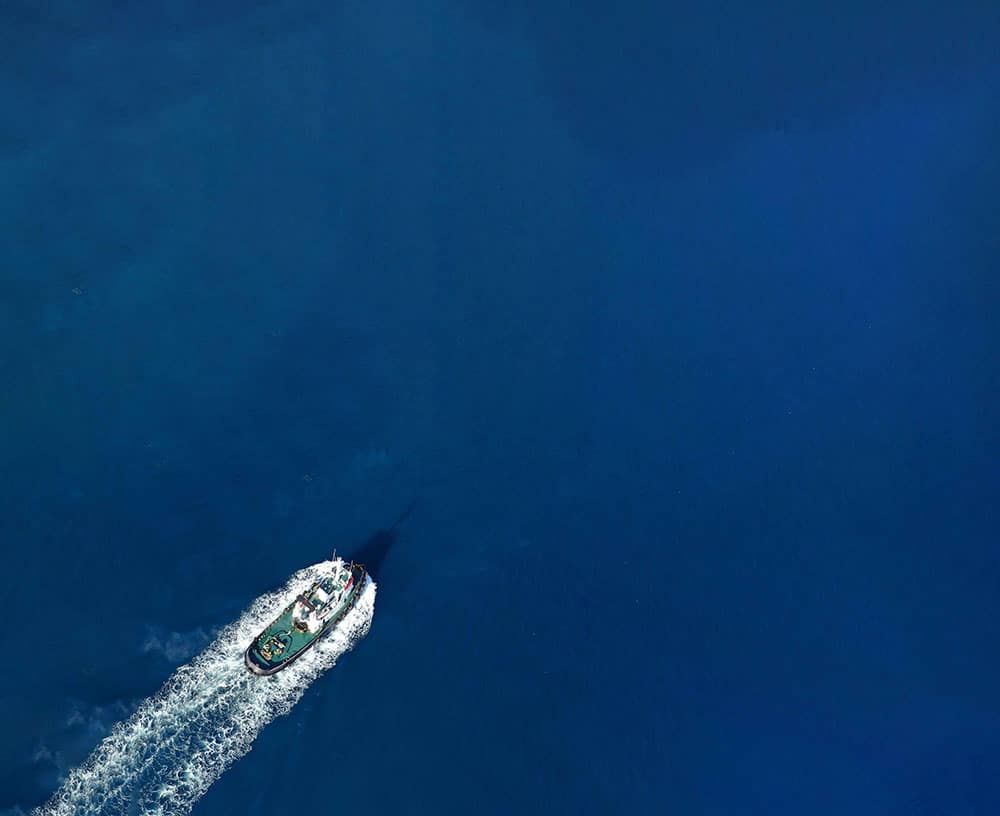 An overview of a maritime vessel sailing calm seas