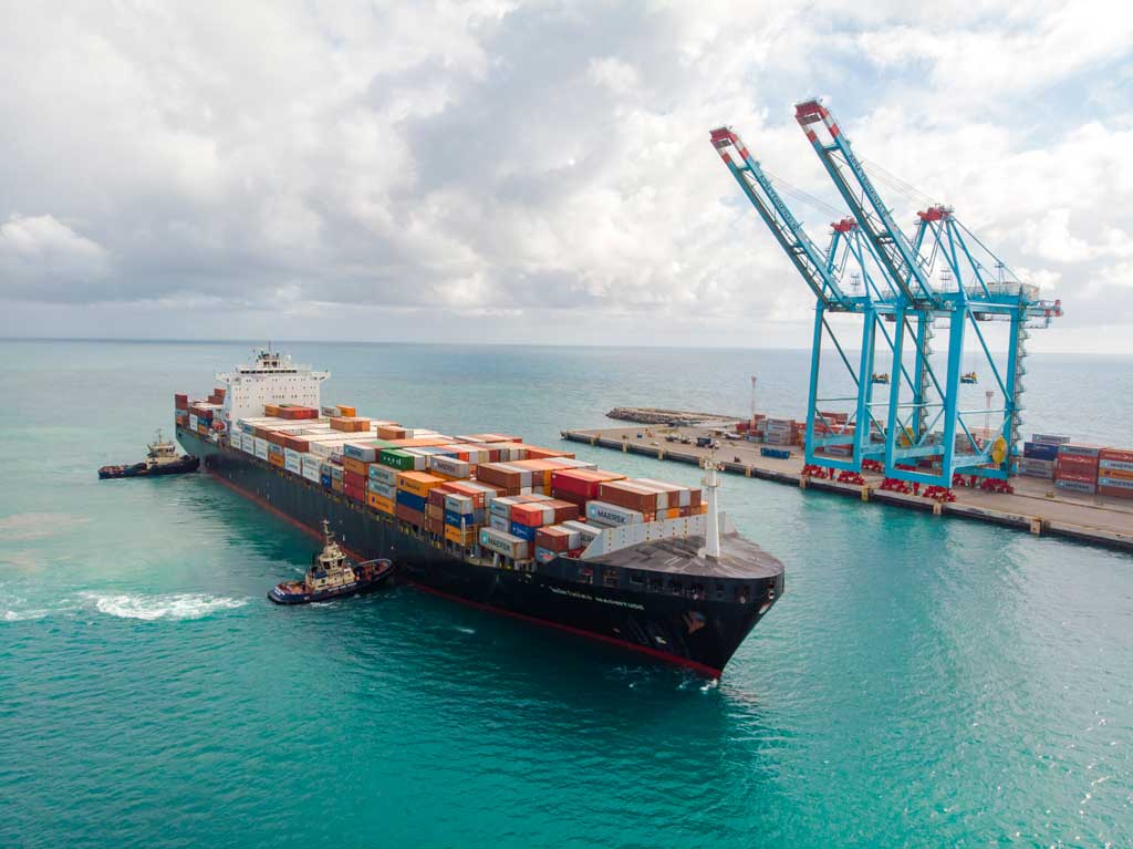 A cargo ship being supported by two SVITZER tugboats at Brazil Harbour Towage