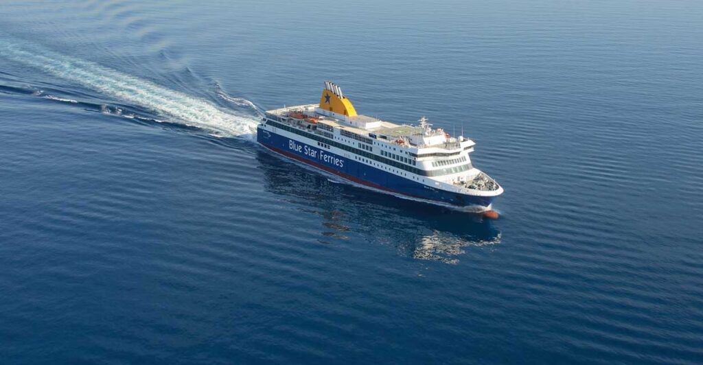 A wideshot of a passenger ship sailing across the sea in great speed