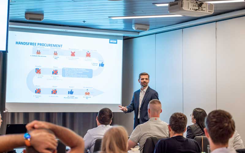 Thomas Toll holding a presentation on handsfree procurement infront of an audience