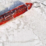 An overview of a maritime icebrekaer vessel breaking its way through ice