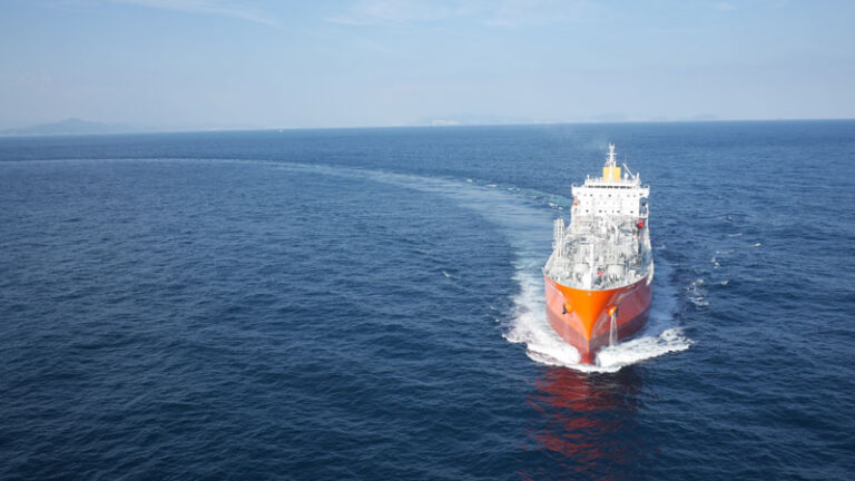 Ultraship tanker sailing across a calm sea, which streetches to the horizon blending with it