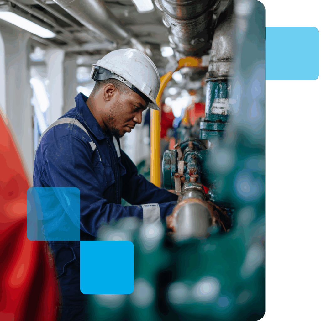 A maritime worker examining pipes