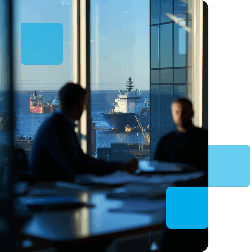 ivisión de los buques de alta mar desde una sala de reuniones, con dos personas discutiendo.